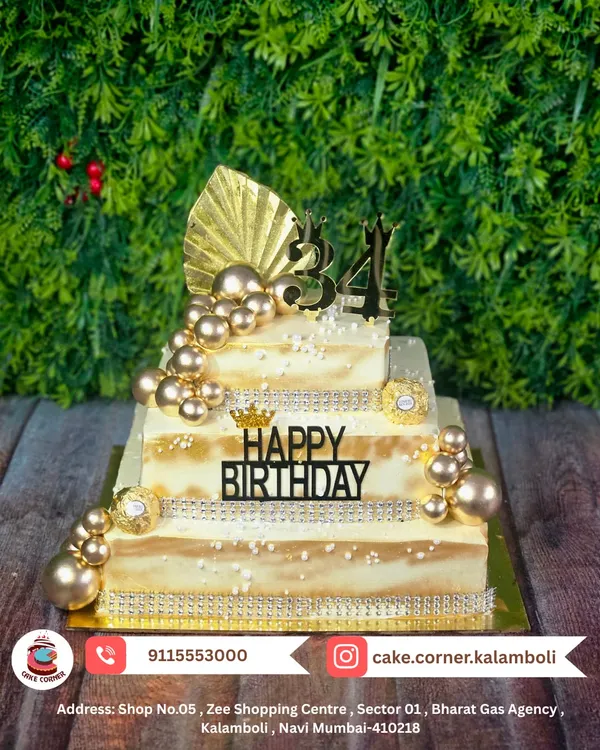 A grand three-tier square cake for a 34th birthday. The white and gold design with pearl details and metallic spheres is the definition of luxury and elegance.