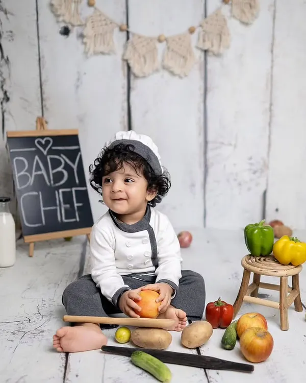 Our little chef is ready to cook up a storm! This sitter session is styled with a chef's uniform, a chalkboard, and plenty of colorful fruits and vegetables.