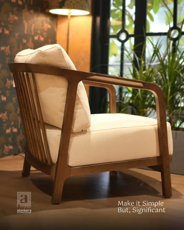 This armchair showcases my minimalist design philosophy. Crafted with a solid teak wood frame and plush cream cushions, it offers significant comfort and timeless style.