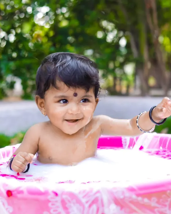 A joyful milk bath session to celebrate a baby's milestone. I love creating these unique, fun setups outdoors, using natural light to capture pure, happy expressions.