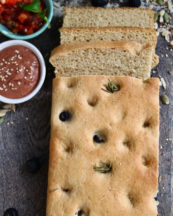 Our freshly baked olive and rosemary focaccia bread. It's made with whole wheat and is perfect for dipping or as a side to your meal. The aroma alone is enough to make you happy.