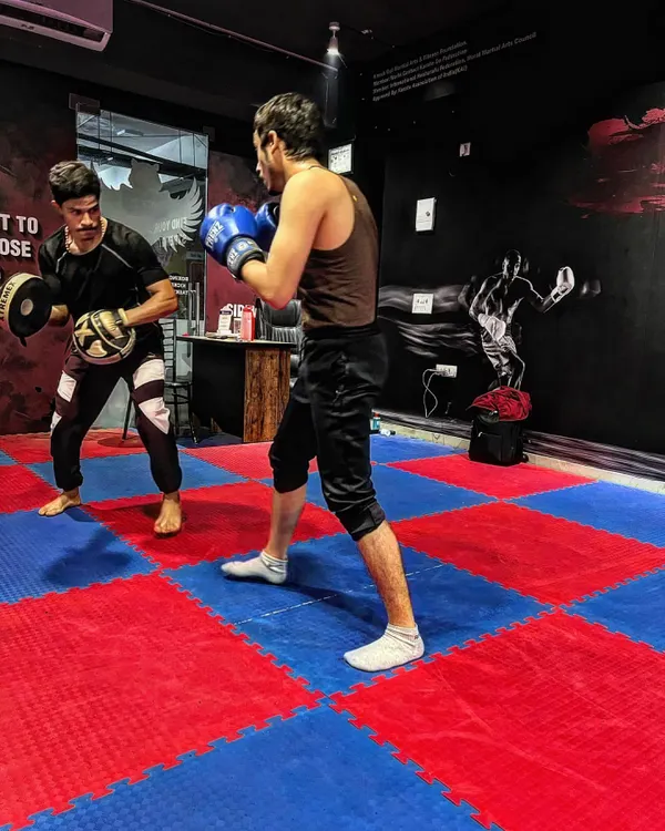During one-on-one pad work, I correct your form in real-time. This drill is for developing speed and precision in your striking, ensuring every punch lands with impact.