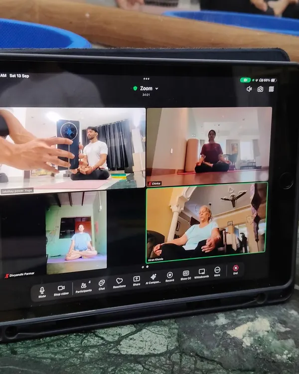 A screenshot of an online Zoom meditation session, showing that you can find your flow and connect with our community from anywhere.