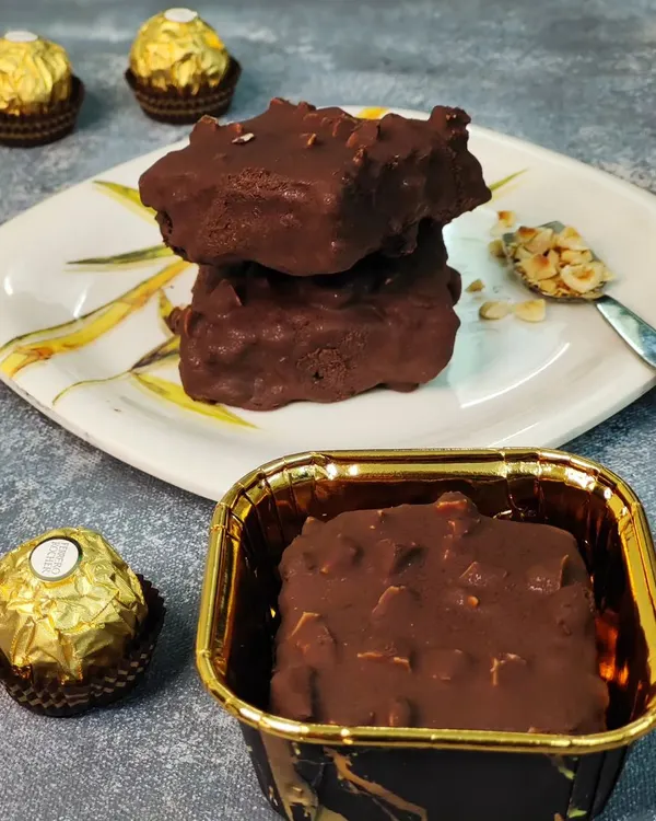 My Ferrero Rocher brownie is the definition of indulgence. It's a rich chocolate brownie coated in a layer of chocolate and toasted hazelnuts, capturing the iconic flavor in every bite.