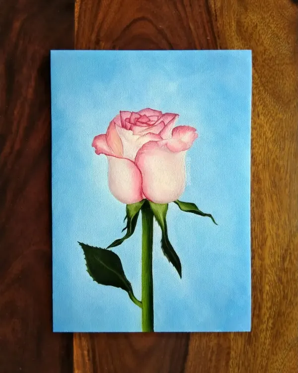 A realistic pink rose painted with oils on A5 paper. Oil paints allow for beautiful, smooth blending, which is perfect for capturing the soft texture of flower petals.
