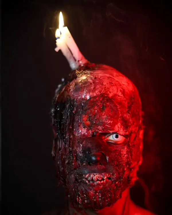 This chillingly realistic burn makeup with a melting candle is a masterclass in SFX artistry. Our students learn to use prosthetics and special materials to create horrifyingly beautiful effects.