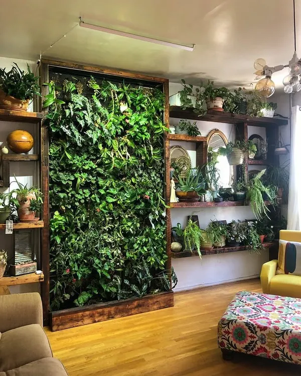 A floor-to-ceiling living wall framed in wood acts as a stunning natural art piece in this living room. It separates the space while adding a massive dose of green.