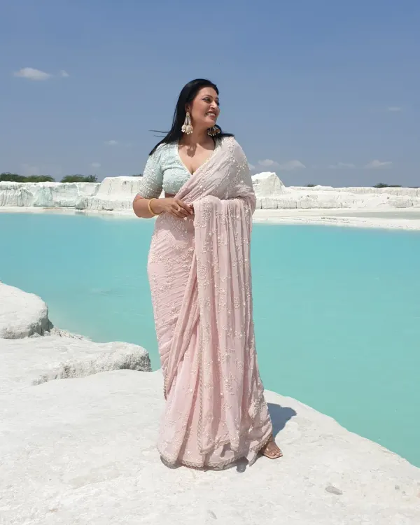 A moment of serenity at the Kishangarh marble dumping yard. This beautiful pastel pink saree with delicate pearl work creates a stunning contrast against the surreal blue water, showing how a saree can be perfect for a dramatic photoshoot.