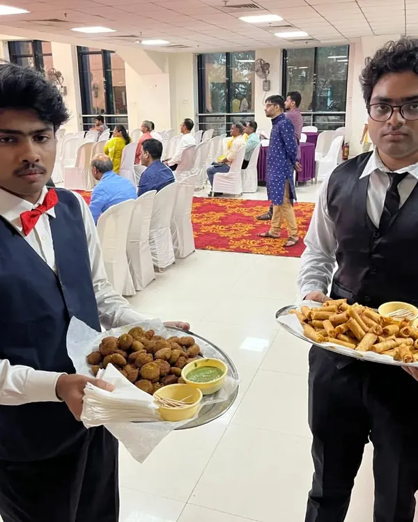 My waiters serving freshly made starters to guests at a naming ceremony in Airoli. On the trays are hara bhara kebabs and veg spring rolls with dipping sauces.