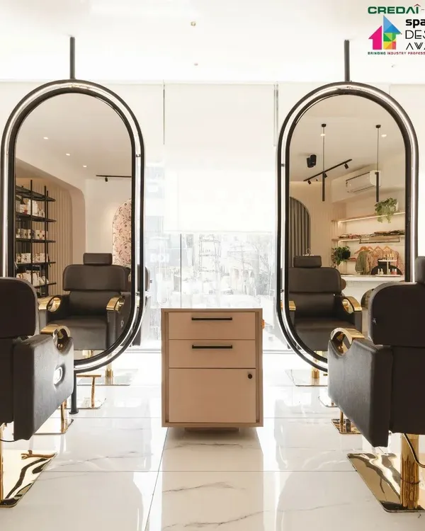 For the 'Frumos' luxury salon, we designed these custom-suspended mirrors. Their elegant, rounded shape and brass accents add a touch of glamour, while the open design maintains a sense of spaciousness.