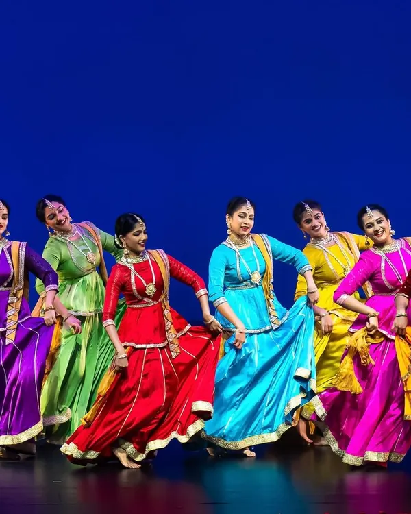 Our dance ensemble performing at a festival in the US, a moment of pure energy and vibrant color that received a standing ovation. This is the kind of stage experience we prepare our students for.