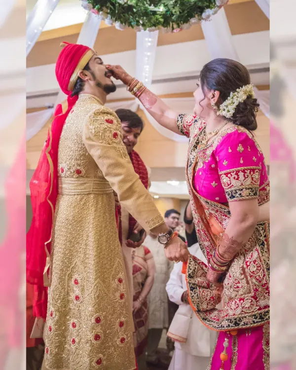 A heartwarming moment from a pre-wedding ritual, where the groom's mother lovingly feeds him. These are the family moments that I strive to capture with authenticity.