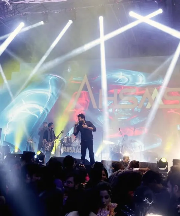 I am experienced in capturing large-scale events with complex stage lighting, like this Sangeet featuring a live band performance. I make sure to get shots of the performers, the crowd, and the overall electrifying atmosphere.