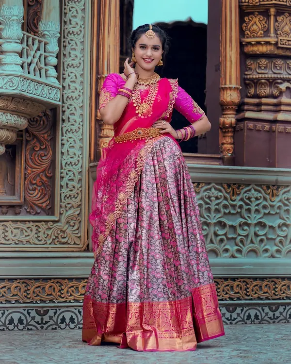 This is the quintessential South Indian bridal look, vibrant and full of joy. I created a flawless HD makeup base that glows, paired with a classic hairstyle and a stunning pink and floral half-saree, perfect for a memorable engagement or pre-wedding ceremony.