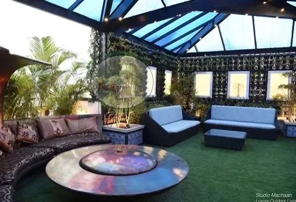 This is what we mean by luxury outdoor living. We designed this terrace with a spacious, all-weather wicker sofa set and a central fire pit table, creating the perfect spot for family gatherings. The entire space is built on a foundation of our zero-maintenance artificial grass, giving you a lush green look without the hassle.