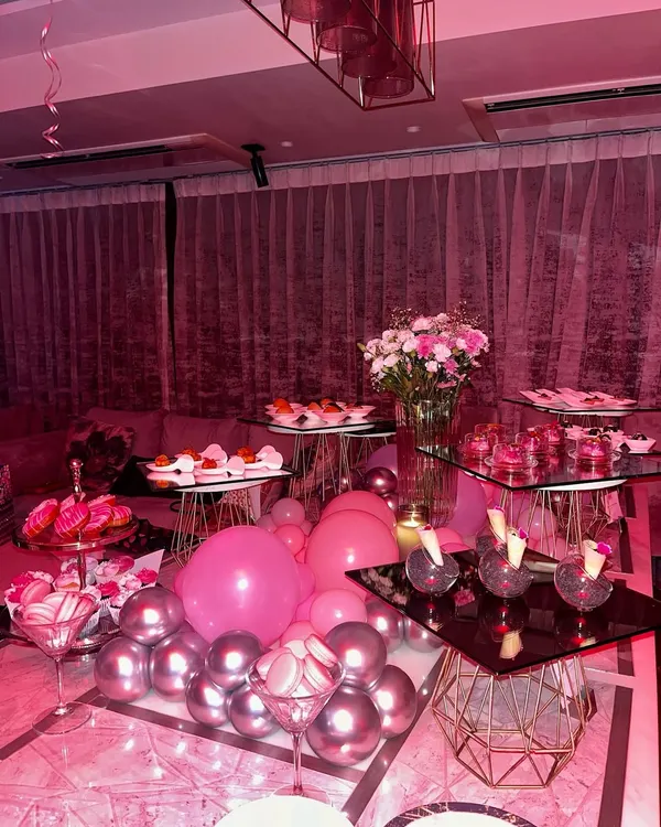 A stunning dessert and appetizer spread for a "Sweet 16" party, bathed in pink light to match the theme. We curated a global feast with mocktails, sushi, tarts, and more.