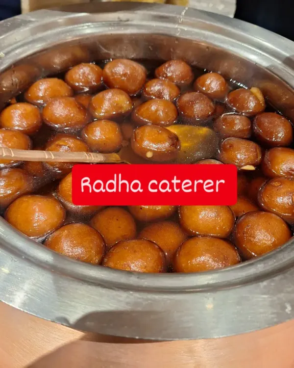 A large pot of our signature Gulab Jamuns, soaking in warm sugar syrup. This is a must-have dessert for any celebration.