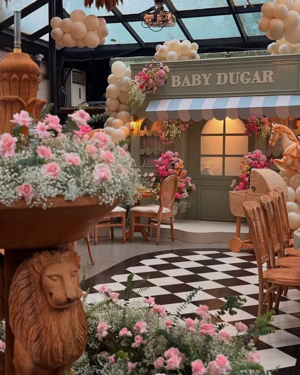 A glimpse into the Parisian-themed "Bonjour Bébé" baby shower, where a custom market stall and lush florals created a charming street-side cafe vibe.