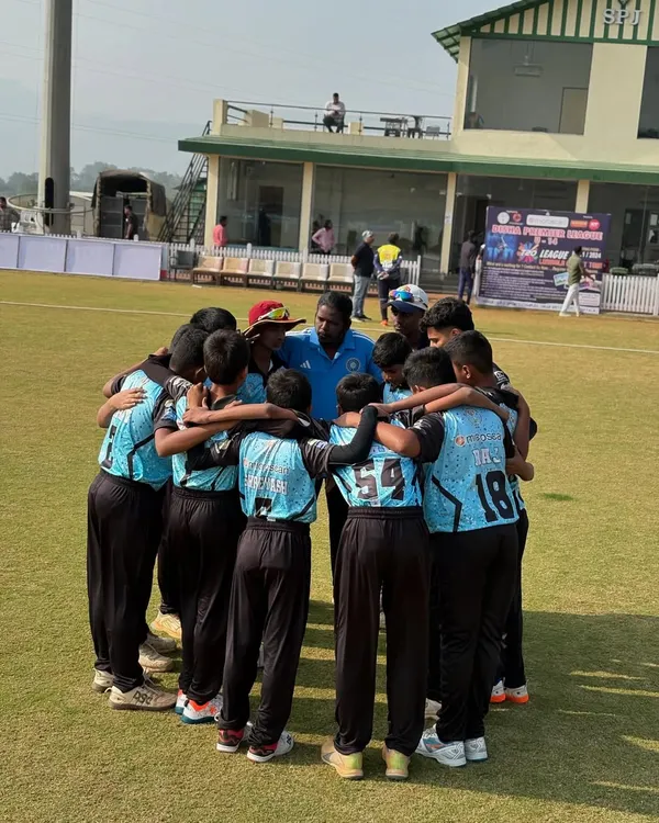 The team in a tight huddle, listening intently to the coach's final words of motivation before taking the field. This is where the game plan is set.