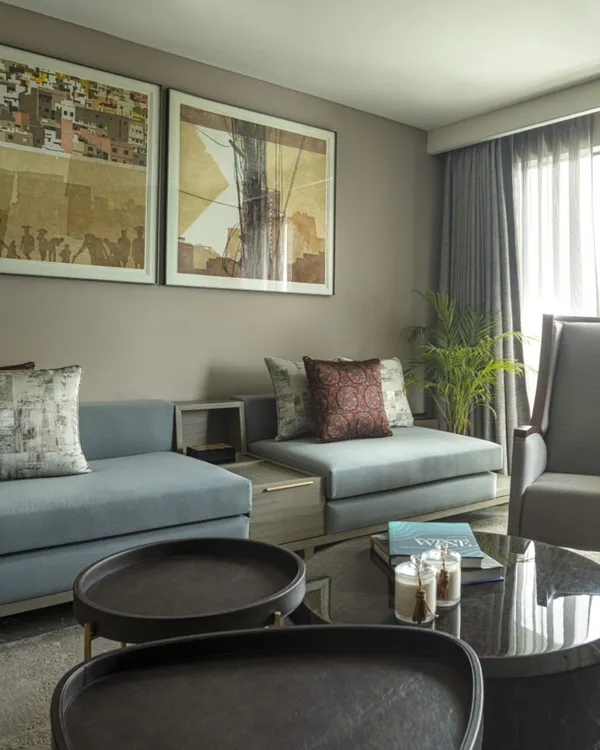 The family lounge at the Jor Bagh Residence, where modern aesthetics meet comfort. The space is carefully crafted with custom low-slung sofas and contemporary art to create a harmonious and visually striking home.