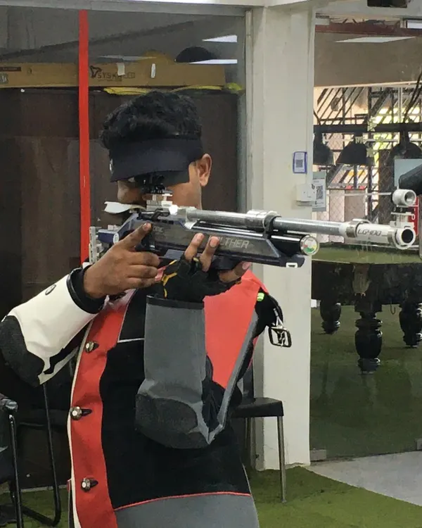 A shooter demonstrates intense focus during a 10m Air Rifle practice session. Notice the precise alignment and steady hold, techniques we drill down to the finest detail.