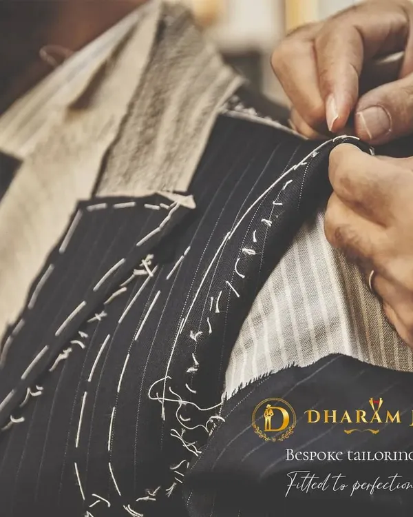 Bespoke tailoring is all about precision. Here, you can see the basting stitches on a suit jacket, a crucial step in hand-crafting a garment that is fitted to perfection for your body.