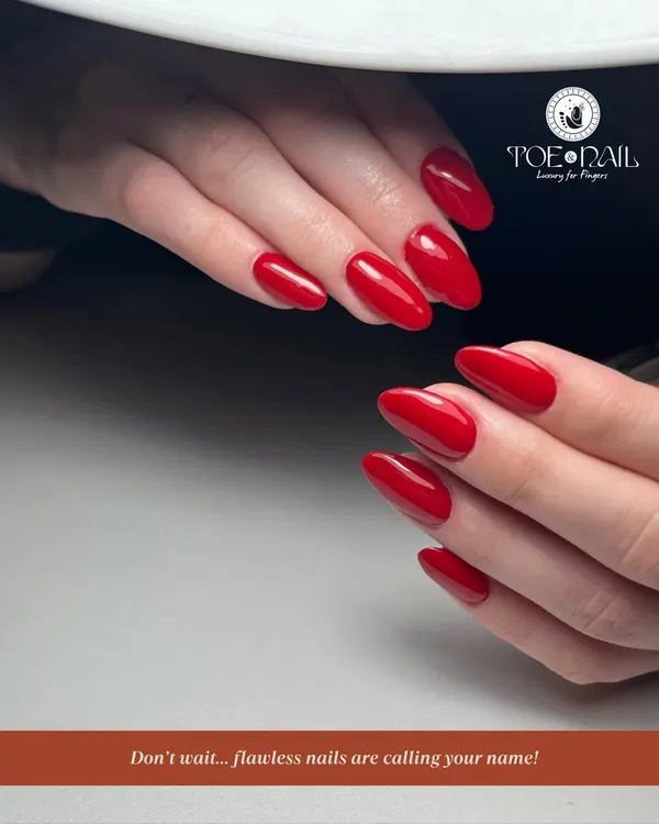 A flawless, classic red manicure on perfectly shaped almond nails. This timeless look showcases the precision and quality I bring to every single service.