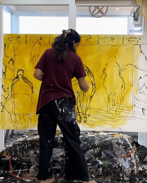 Me in my element, working on a large-scale canvas. The initial stages often involve loose sketches and laying down the first layers of color to map out the composition.