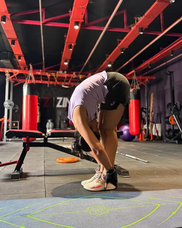 A deep forward fold stretch after a workout. Flexibility is key to preventing injuries and improving your dance movements, so we always make time for a proper cool-down.