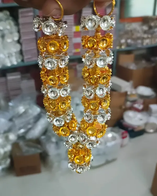 A beautiful haaram made of gold and silver colored stones. This garland is perfect for decorating deity photos or idols (Amma vaari alankarana).