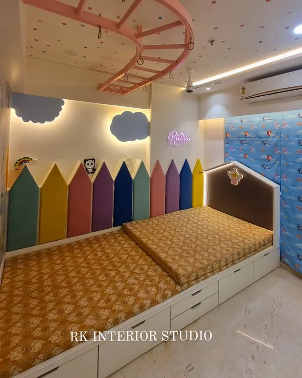 A child's room should be a place for imagination to grow. This kids' bedroom features a colorful pencil-themed headboard, custom beds with built-in storage drawers, and a playful, space-themed wall to create a fun and functional environment.
