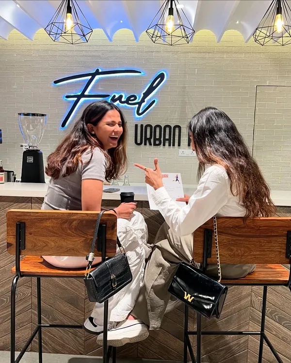 The BlackBx experience goes beyond the workout. Here are two members enjoying a laugh and a coffee at Fuel by Urban Fork.