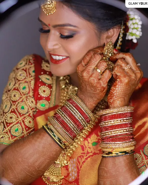 Sheer elegance for a muhurtham ceremony. This bride is confidently carrying her super glam traditional makeover, featuring bold eyes, a classic red lip, and a flawless base that glows under the lights.