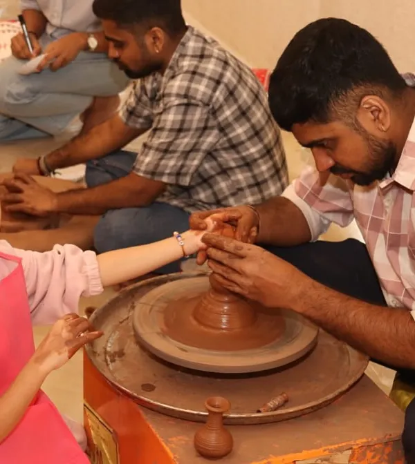 A young girl gets her first lesson in pottery, guided by one of our instructors. This tactile activity is a wonderful way to explore physics and creativity at the same time.