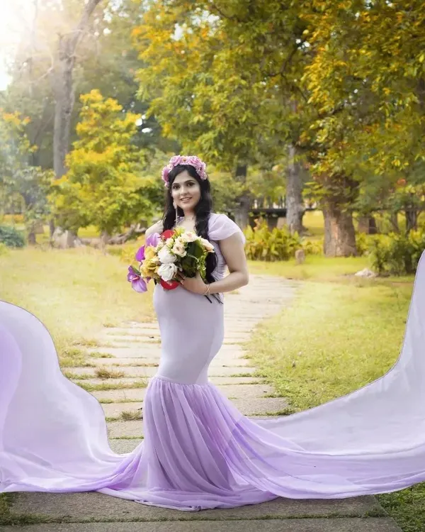 A beautiful maternity shoot in a park setting. I styled the mom-to-be in a flowing lavender gown with soft makeup to highlight her pregnancy glow, creating a serene and magical portrait.