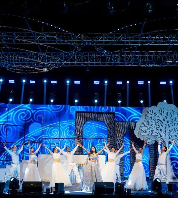 A wide view of one of our grand stage setups. This production featured a massive trussing rig for lighting, a custom LED screen with animated graphics, and large set pieces like the tree and archway to create a complete visual world.