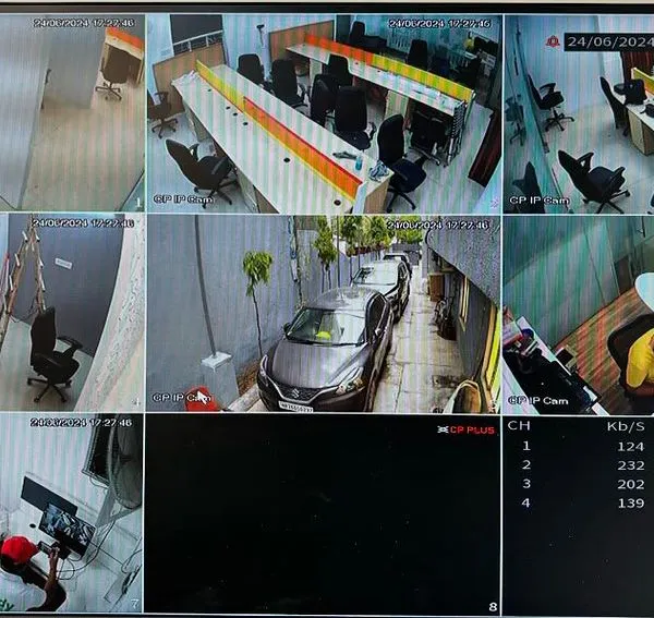 A live multi-camera view from a recent office installation in Gurgaon. This system uses CP Plus IP cameras to provide comprehensive coverage of workstations, entry points, the parking area, and private cabins, all visible on a single screen.