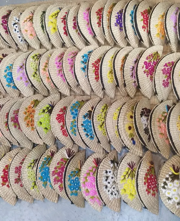 This image captures the beautiful variety in our collection of hand-embroidered clutches. Lined up, they showcase the range of colors and floral patterns available, all handcrafted by artisans. We can supply these in large quantities for retail or corporate gifting.