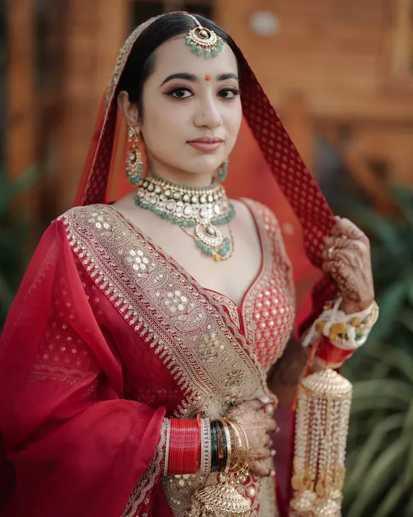 A close up portrait focusing on the bride's serene expression and exquisite jewelry. We use natural light to highlight the intricate details of the bridal look.