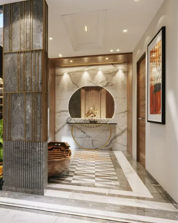 This central atrium is designed as an experience, not just a passage. The interplay of a patterned marble floor, a textured stone pillar, and a circular mirror creates a powerful visual statement.