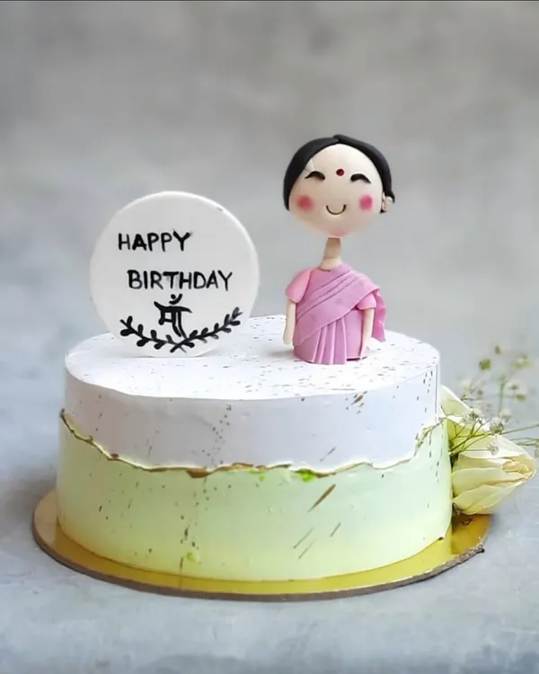 A birthday cake for Maa, made with so much love. This fault-line cake features a hand-sculpted fondant figure in a saree, making it a deeply personal and sweet tribute.