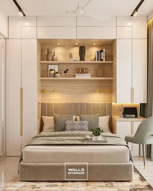 This master bedroom unit is a perfect example of our integrated design approach. We built a floor-to-ceiling wardrobe system that incorporates a bed with a custom headboard, ambiently lit display shelves, and a compact study corner, creating a complete and cohesive space.