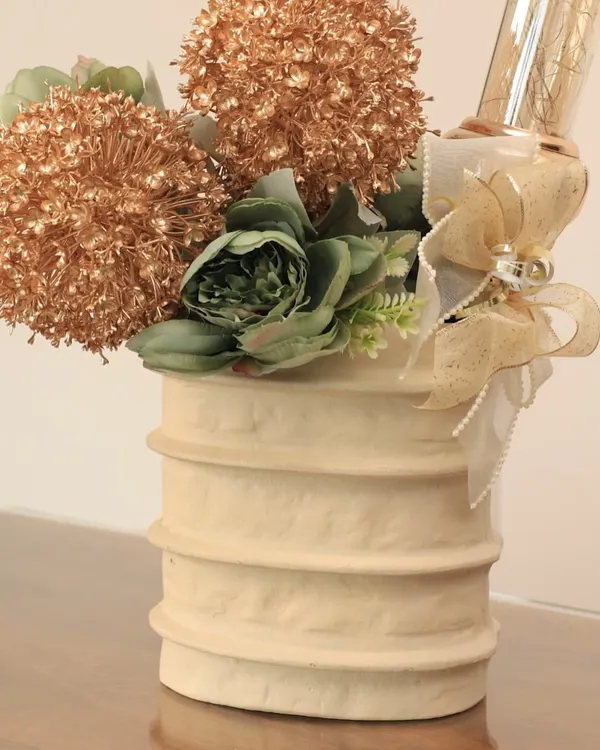 Our Moonlit Ivory Ceramic Vase, styled here with a festive arrangement. This timeless piece is a blank canvas, ready to adapt to any mood, from minimal to celebratory.