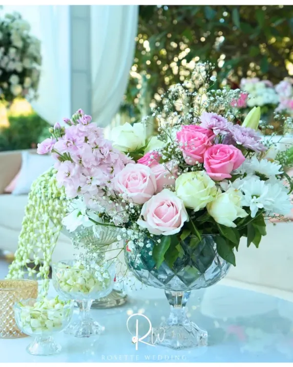 Every corner deserves a bloom. This elegant centerpiece features a mix of pink and white roses, stock flowers, and baby's breath in a crystal-cut vase.