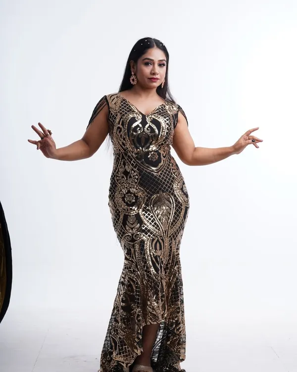 Own the spotlight in this stunning black and gold sequin mermaid gown. The intricate pattern and flattering silhouette are perfect for making a statement at any event.