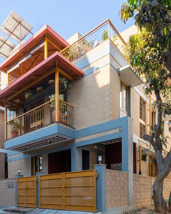 The Audumbara residence, seen from the street. The design features deep, shaded balconies, Mangalore tile roofing, and solar panels, all working together to create a climate-responsive home.