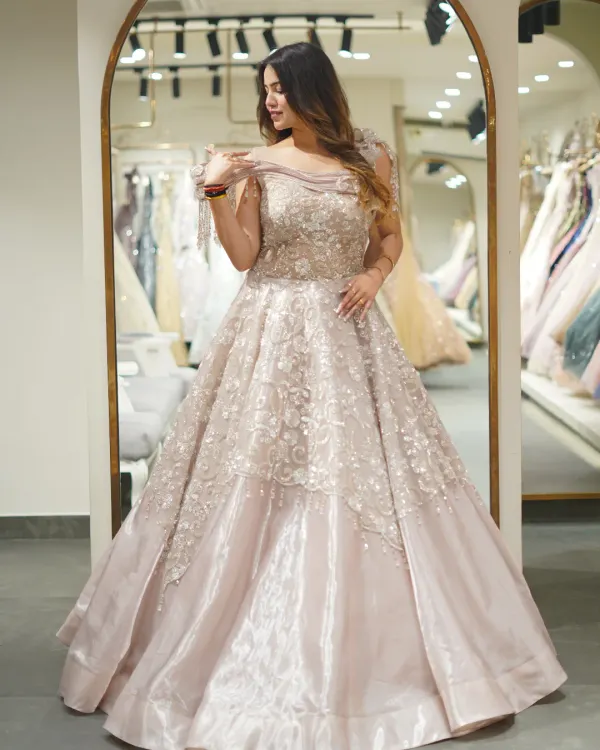 This is the fairytale moment you've been dreaming of. I designed this voluminous ball gown with intricate floral embroidery and a touch of sparkle to make you feel like royalty at any grand reception or engagement.