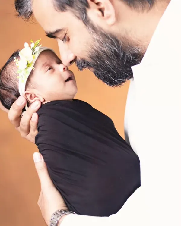 A father's gentle love for his newborn. These intimate moments are the heart of our family photography sessions.