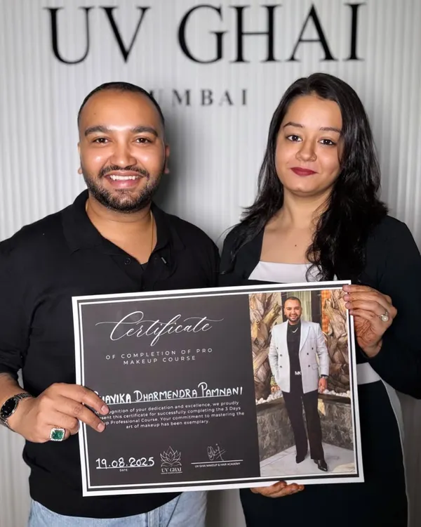 A photo of me receiving a certificate of completion for a pro makeup course from UV Ghai, showcasing my commitment to continuous learning.