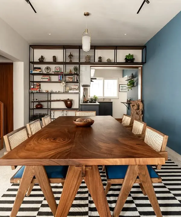 For us, a home is a place for connection. This solid wood dining table, intentionally placed at the heart of a renovated house, serves as a testament to that belief. It’s a space designed not just for meals, but for conversations, laughter, and the creation of memories, surrounded by the client's personal collection of art and travel artifacts.